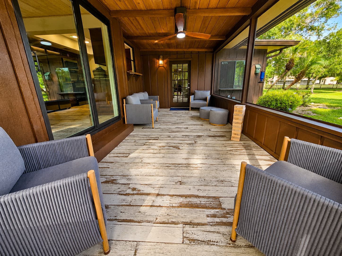 Covered porch with wood ceiling, fan and outdoor games