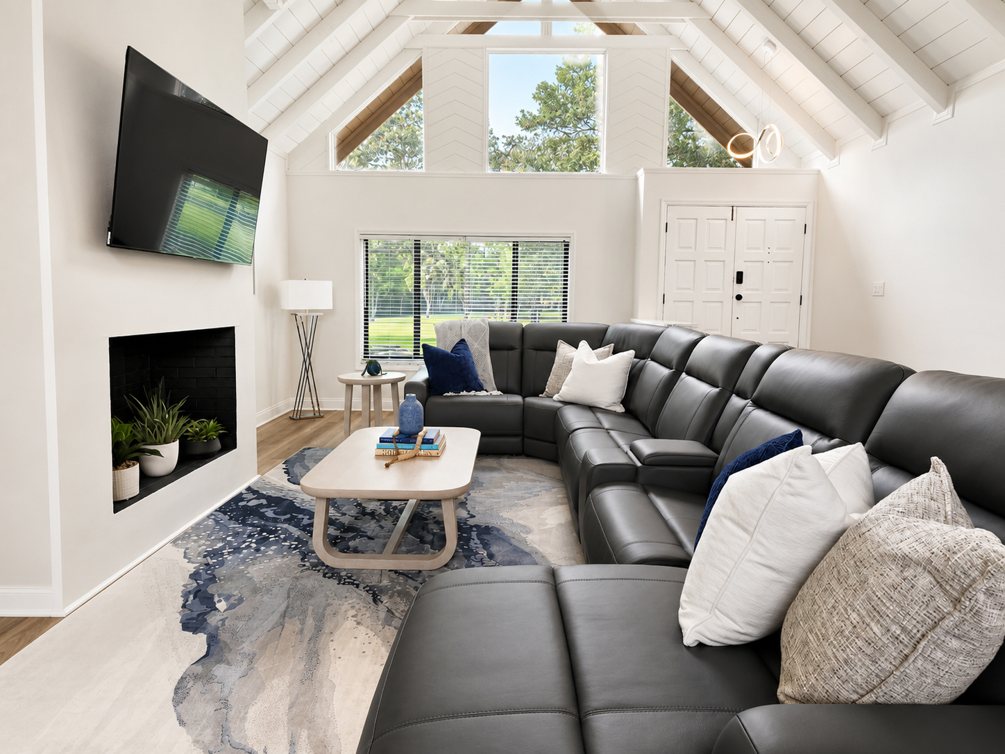 Vaulted-ceiling living room with sectional sofa and fireplace