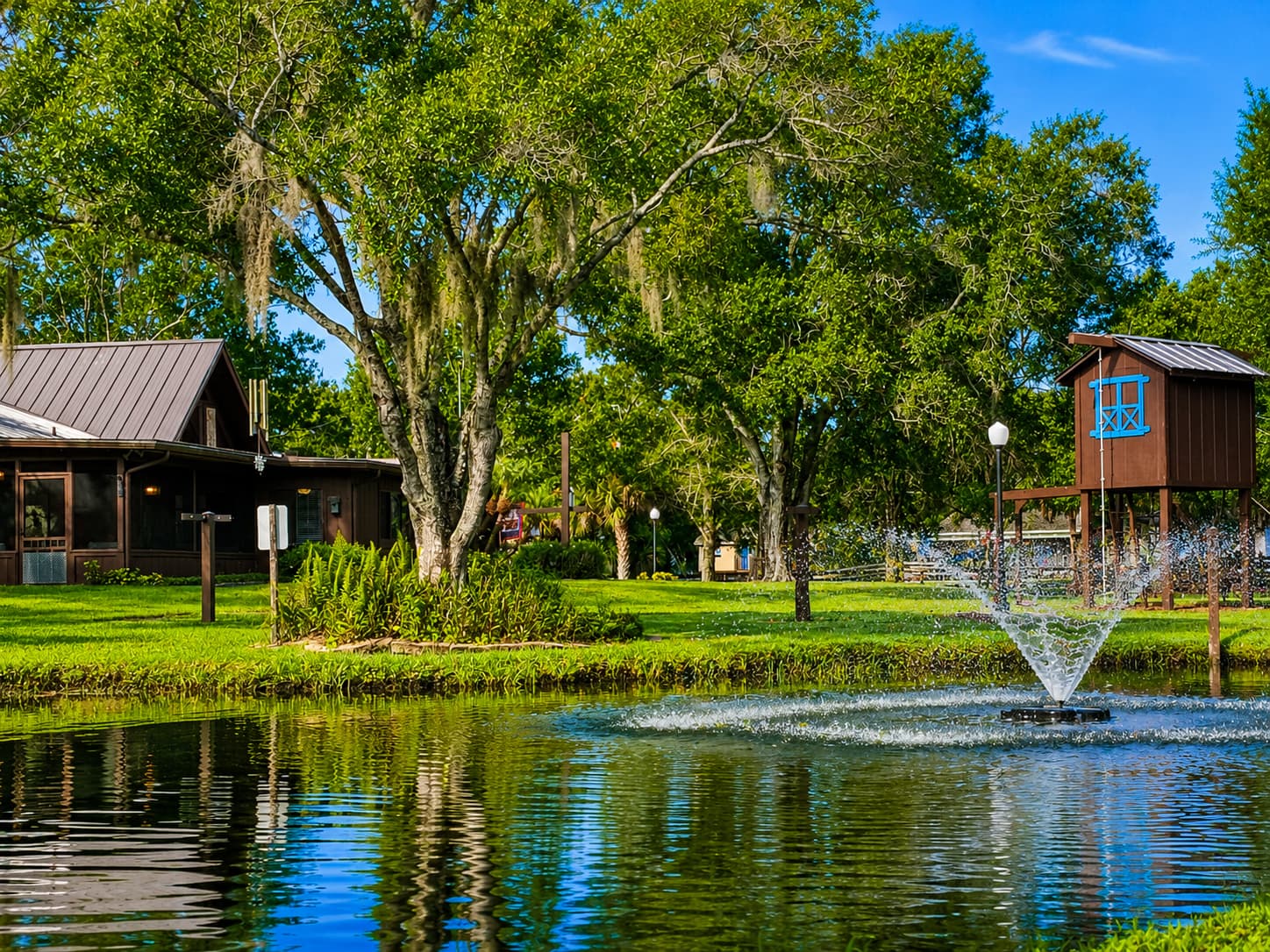 Pond with fountain and screened porch beyond
