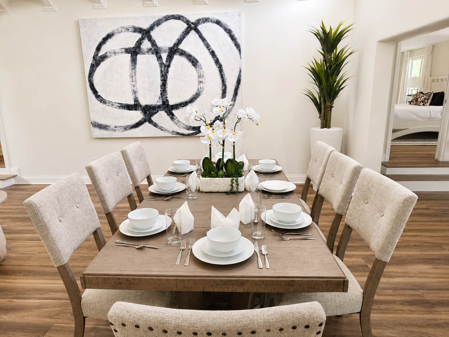 Dining room with orchid centerpiece and abstract artwork